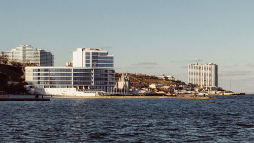 View of sea with buildings in background