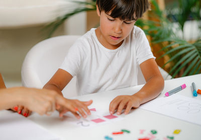 Child recognizing shapes in a preschool assessment test.