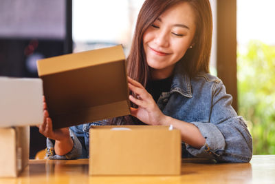 Young woman using laptop while sitting on sofa at home