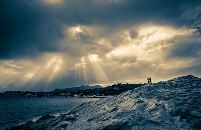 Scenic view of mountains against cloudy sky