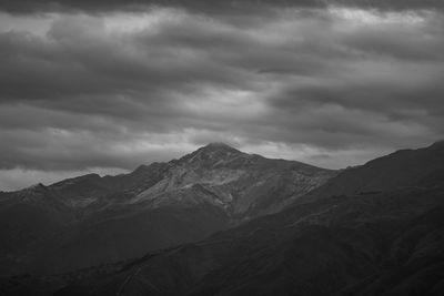 Scenic view of mountains against cloudy sky