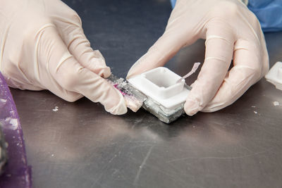 Scientist preparing paraffin blocks containing biopsy tissue for sectioning. pathology laboratory. 