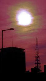 Low angle view of built structures at sunset