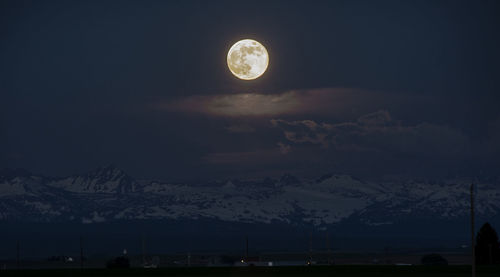 Scenic view of snowcapped mountains against sky at night