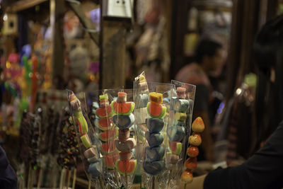 Close-up of hand holding glass for sale at street market