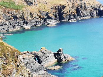 High angle view of rocks by sea