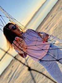 Portrait of woman holding sunglasses