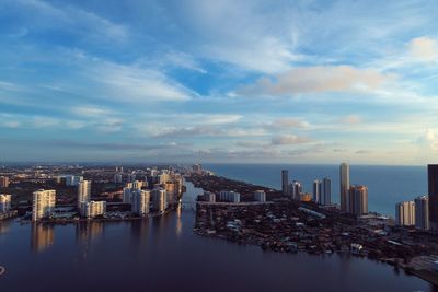 Panoramic view of sea and buildings against sky