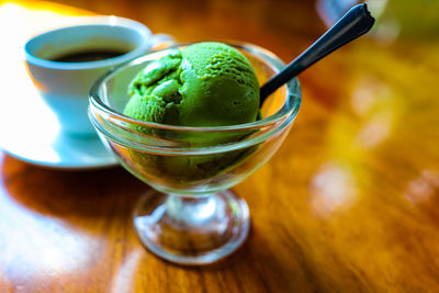 Close-up of green tea ice cream in glass on table