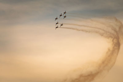 Low angle view of airplane flying against sky