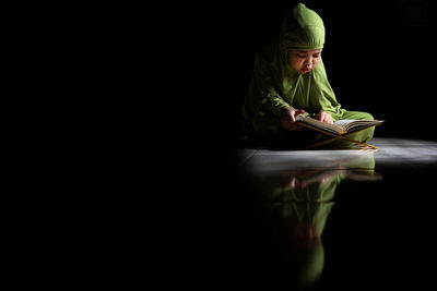 Girl sitting on book