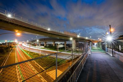 Light trails on street against sky at night