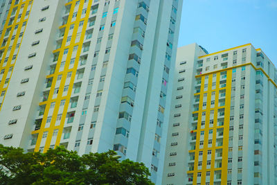 Low angle view of buildings against clear blue sky