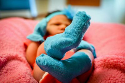 Close-up of toddler lying on bed