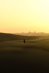 Scenic view of desert against sky during sunset