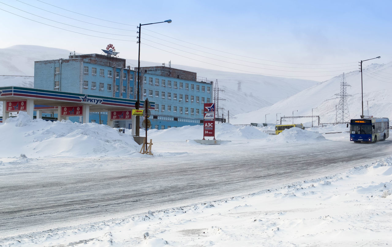 winter, snow, architecture, cold temperature, building exterior, built structure, sky, transportation, nature, mode of transportation, white color, land, land vehicle, day, building, covering, mountain, beauty in nature, outdoors, no people, snowcapped mountain