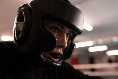 Determined female boxer in protective gear ready for fight