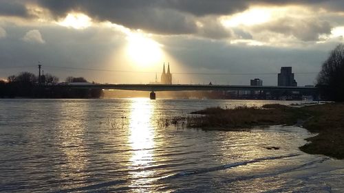 View of bridge over river against cloudy sky