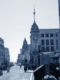 View of clock tower in city against clear sky