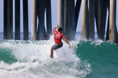 Full length of man splashing water in sea