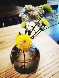 Close-up of yellow flower in vase on table