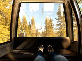 Low section of man in overhead cable car