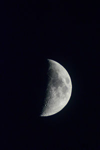 Low angle view of half moon against sky at night