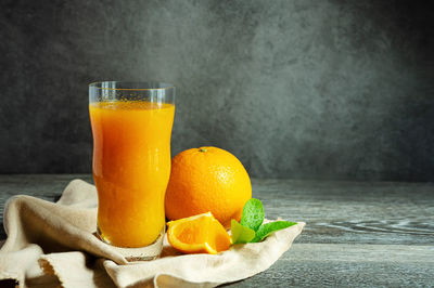 Close-up of orange juice on table