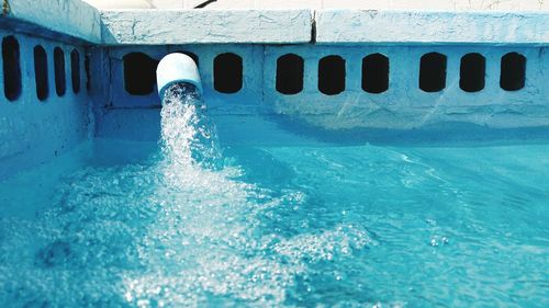 Water from pipe falling in swimming pool