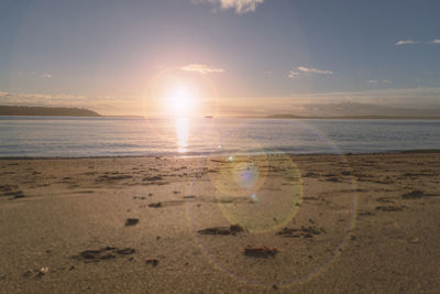 Scenic view of beach against sky during sunset