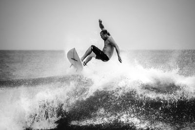 Woman jumping in sea
