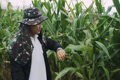 Man checking time while standing at farm