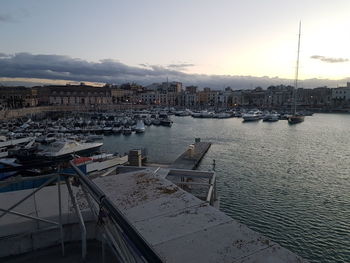 Sailboats in city at sunset