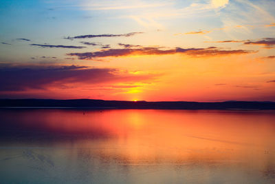 Scenic view of lake against romantic sky at sunset