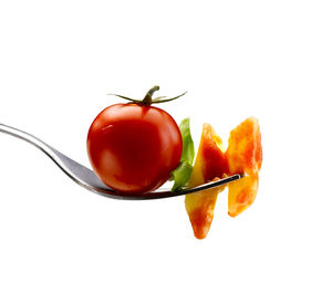 Close-up of tomatoes against white background