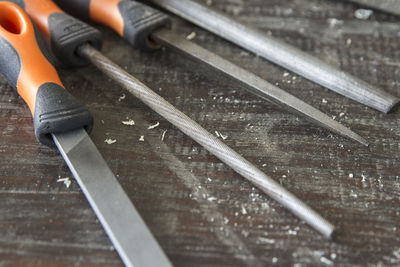 High angle view of work tools on wooden table