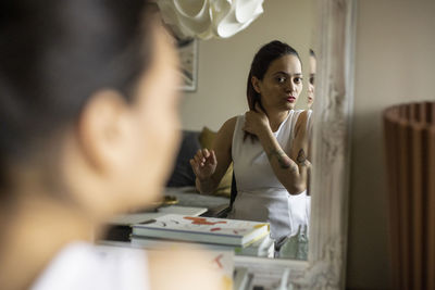 Woman with disability getting ready while looking in mirror at home