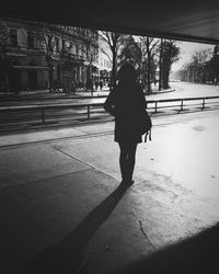 Rear view of woman walking in snow