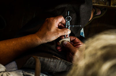 Violin maker luthier changing bridge of a handmade baroque violin