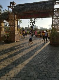 People walking in temple against sky