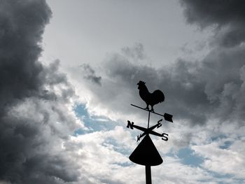 Low angle view of street light against cloudy sky