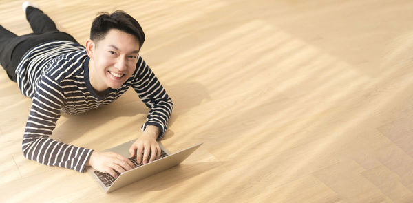 High angle view of smiling woman using mobile phone