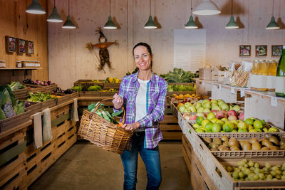 Portrait of smiling woman standing in market