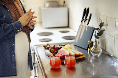 Mid section of woman preparing healthy snacks
