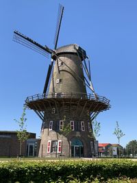 Traditional windmill against clear blue sky