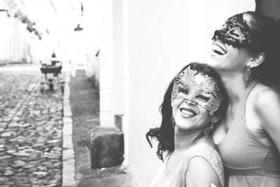 Portrait of two women wearing venice carnival mask. 