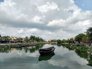 Boats moored in lake against sky