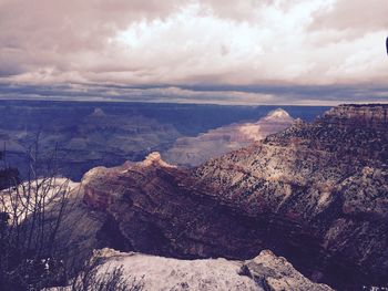 Scenic view of mountains against cloudy sky