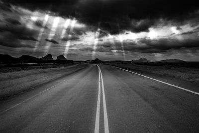 Empty road along countryside landscape