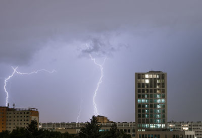 Lightning in sky above city at night